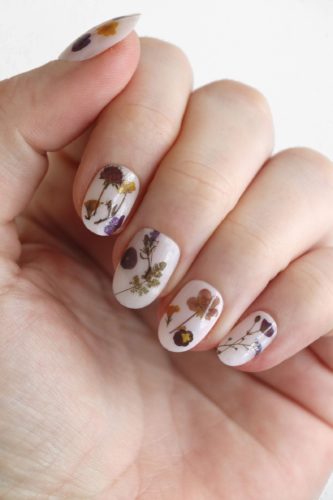 Dried flower nail stickers from Etsy seen on white nails - nail art, flower nail design